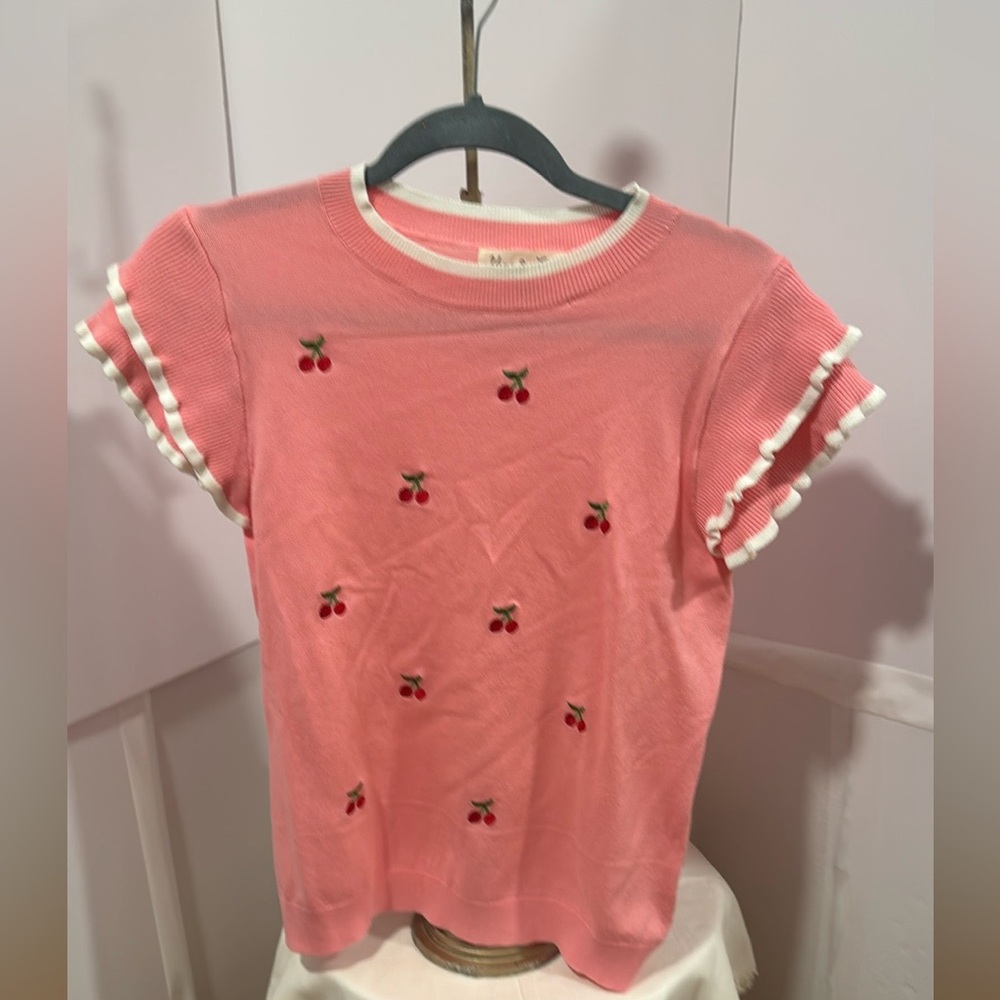 Pink knit top with embroidered cherries all over the front. size M